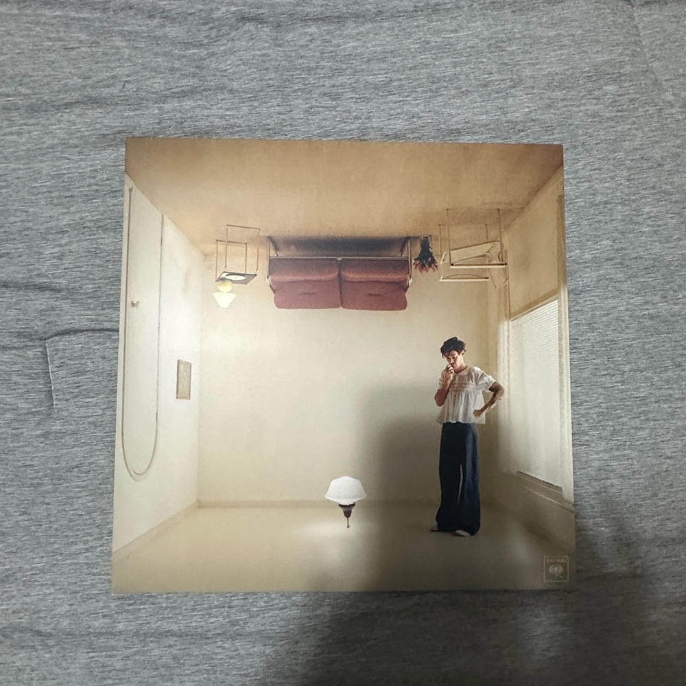 An unopened orange harry’s house vinyl